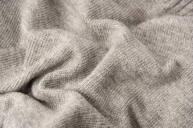 Arka plan olarak gri yün süveter dokusu. Üst görünüm.