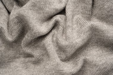 Arka plan olarak gri yün süveter dokusu. Üst görünüm.