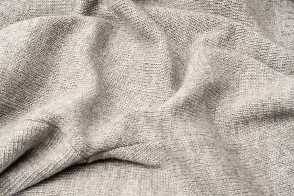 Arka plan olarak gri yün süveter dokusu. Üst görünüm.