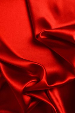 Kırmızı ipek ya da saten lüks kumaş dokusu soyut bir arka plan olarak kullanılabilir. Üst görünüm.