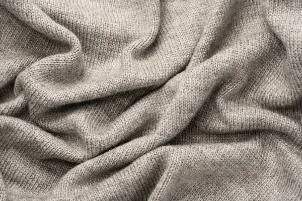 Arka plan olarak gri yün süveter dokusu. Üst görünüm.