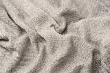 Arka plan olarak gri yün süveter dokusu. Üst görünüm.