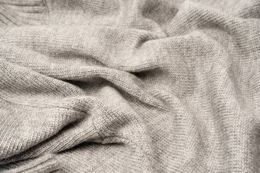 Arka plan olarak gri yün süveter dokusu. Üst görünüm.