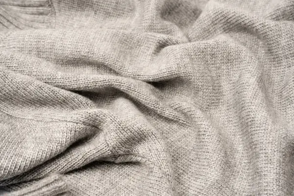 Arka plan olarak gri yün süveter dokusu. Üst görünüm.