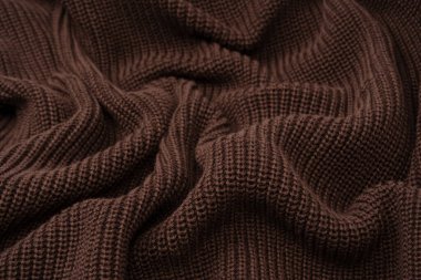 Arka plan olarak kahverengi süveter dokusu. Üst görünüm. 