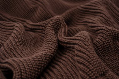 Arka plan olarak kahverengi süveter dokusu. Üst görünüm. 