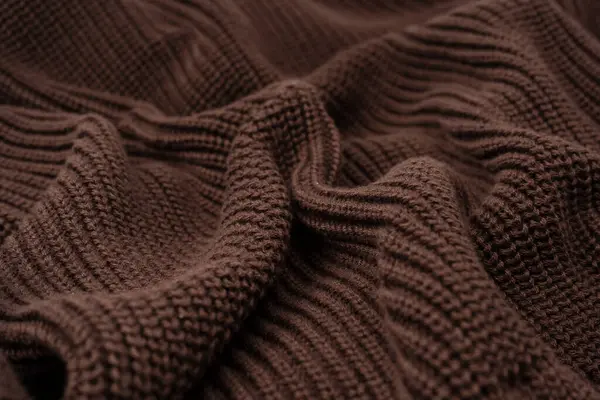 Arka plan olarak kahverengi süveter dokusu. Üst görünüm. 