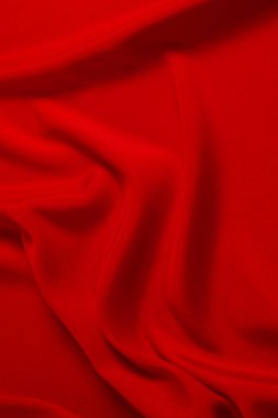 Kırmızı ipek ya da saten lüks kumaş dokusu soyut bir arka plan olarak kullanılabilir. Üst görünüm.