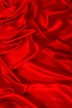 Kırmızı ipek ya da saten lüks kumaş dokusu soyut bir arka plan olarak kullanılabilir. Üst görünüm.