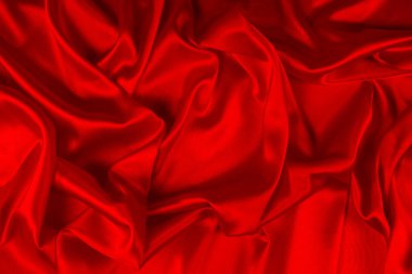 Kırmızı ipek ya da saten lüks kumaş dokusu soyut bir arka plan olarak kullanılabilir. Üst görünüm.