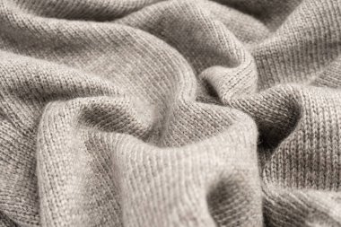 Arka plan olarak gri yün süveter dokusu. Üst görünüm.