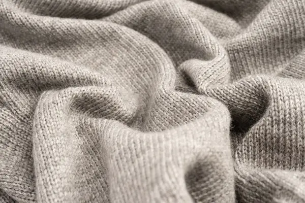 Arka plan olarak gri yün süveter dokusu. Üst görünüm.