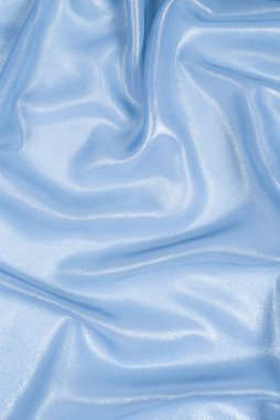 Arka plan olarak mavi parlak inci kumaş. Üst görünüm. 