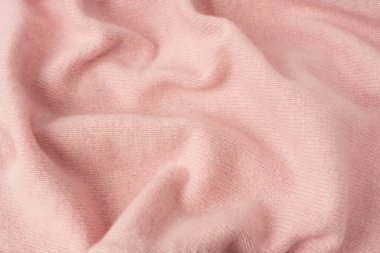 Yumuşak pembe kaşmir süveter desenli arka plan. Üst görünüm. 