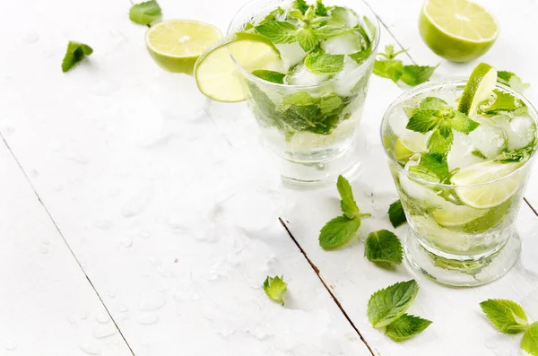 stock image Fresh cold lime mojito on white table