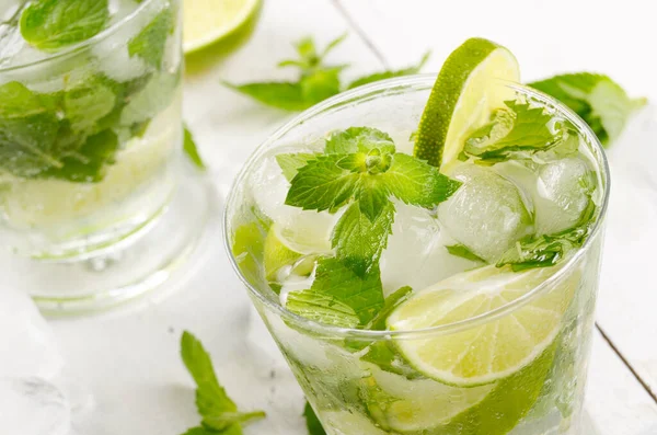 stock image Fresh cold lime mojito on white table