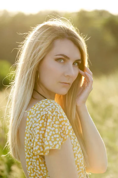 stock image Young blond caucasian female model enjoying outdoor activity at meadow summer evening time