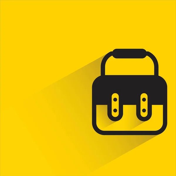 黄色の背景に影のあるブリーフケース — ストックベクタ