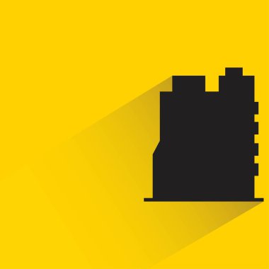 Sarı arkaplanda gölgesi olan siluet şehir binası simgesi