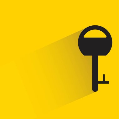 key with shadow on yellow background