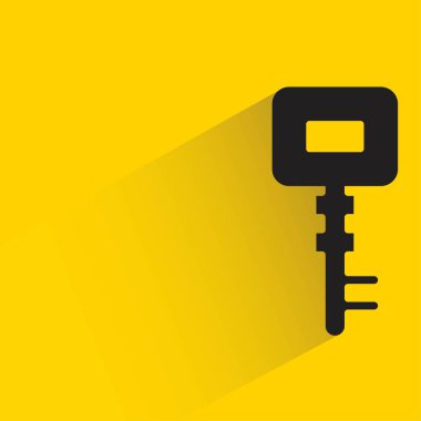 key with shadow on yellow background