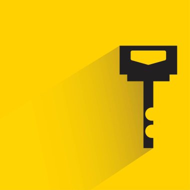 key with shadow on yellow background