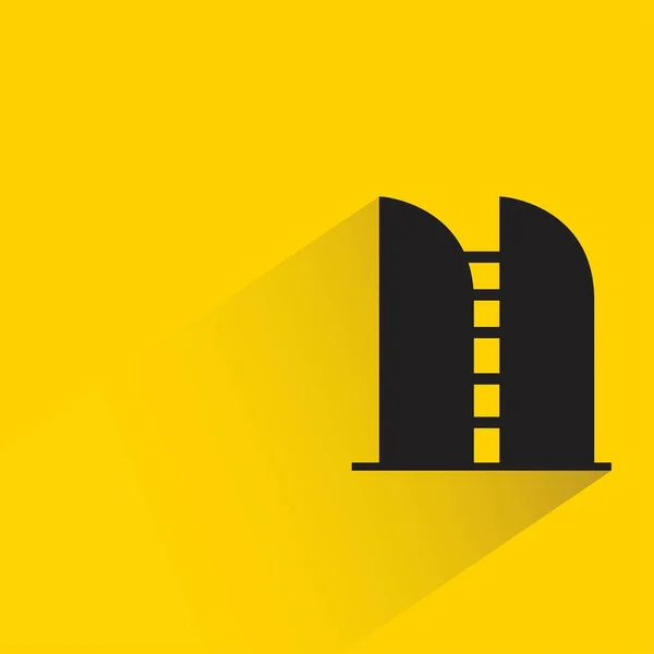 Silueta Icono Del Edificio Oficinas Con Sombra Sobre Fondo Amarillo — Vector de stock