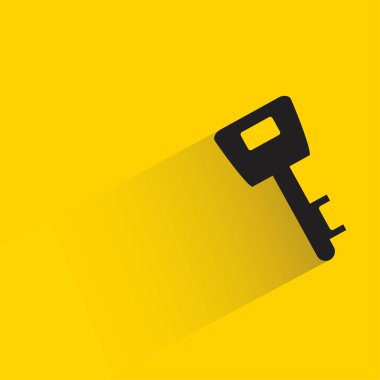 key with shadow on yellow background