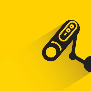 security camera with shadow on yellow background