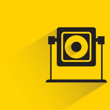 security camera with shadow on yellow background