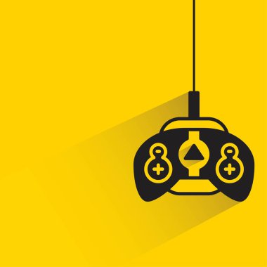 Sarı arkaplanda gölgesi olan oyun joystick 'i