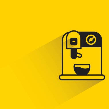 Sarı arka planda gölgesi olan kahve makinesi.