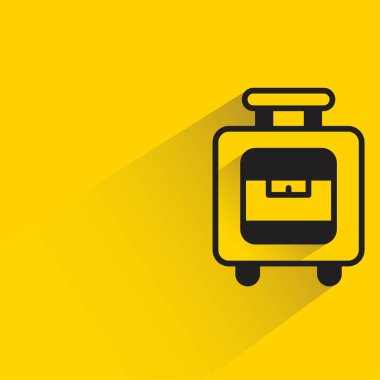 sarı arka planda gölgesi olan valizler