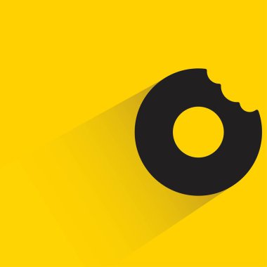 Sarı arka planda gölgesi olan donut tatlısı.