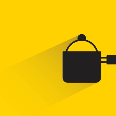 Sarı arka planda gölgesi olan tencere.