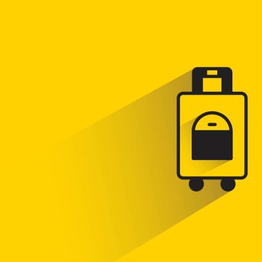 sarı arka planda gölgesi olan valizler