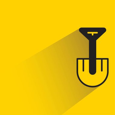 Sarı arkaplanda gölgesi olan kürek simgesi