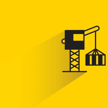 Sarı arkaplanda gölgesi olan inşaat vinç simgesi