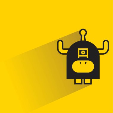 Sarı arka planda gölgesi olan sevimli canavar karakter.