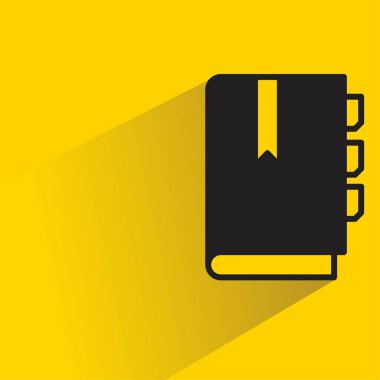 Sarı arkaplanda gölgesi olan kitap simgesi