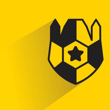 Sarı arkaplanda gölgesi olan kalkan sembolü