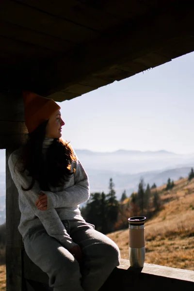 Young Woman Beanie Thermos Sitting Wooden House Front Mountains Landscape — Stock Photo, Image