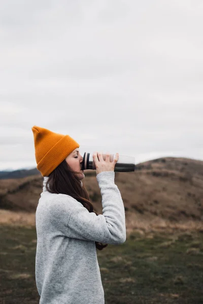 Young Woman Orange Beanie Hat Drinking Tea Thermos Outdoors Front — Stock Photo, Image