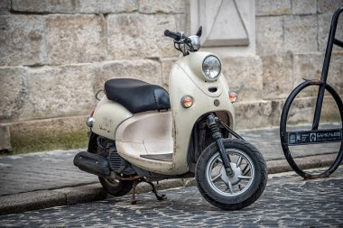 vintage scooter in a street clipart