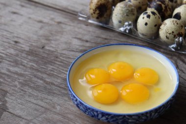 Ahşap arka planda çiğ bıldırcın yumurtası