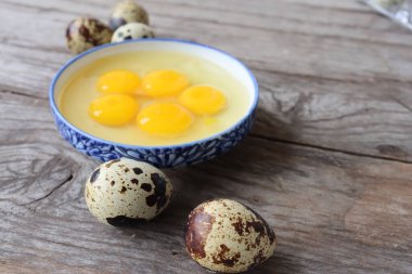 Ahşap arka planda çiğ bıldırcın yumurtası