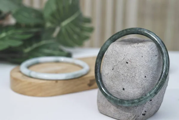 stock image Jade bangle product with tropic leaves