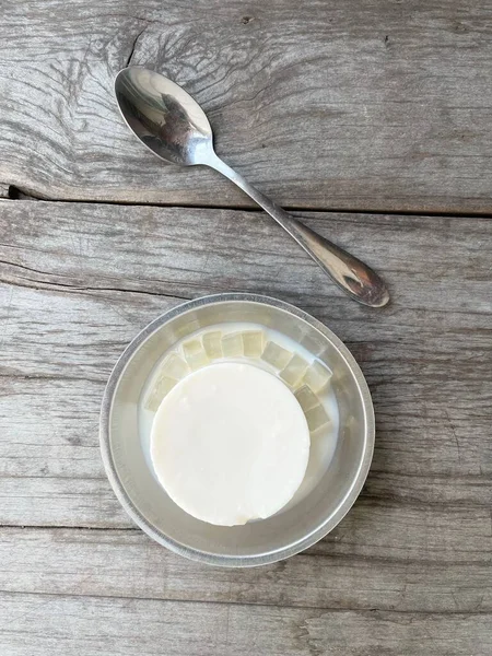 Milk pudding on wood background