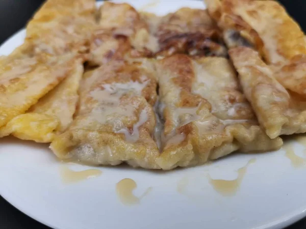 stock image Roti with banana and egg on black background