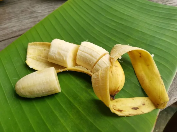 バナナは木の背景にスライスして葉 — ストック写真